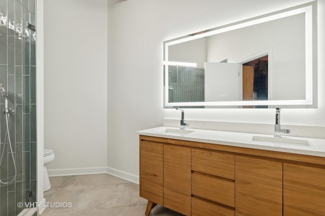 bathroom featuring vanity, walk in shower, tile patterned floors, and toilet