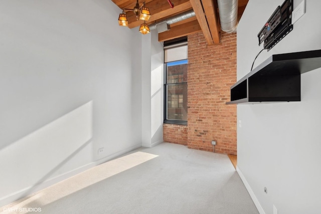 interior space featuring beamed ceiling, brick wall, carpet flooring, and wooden ceiling