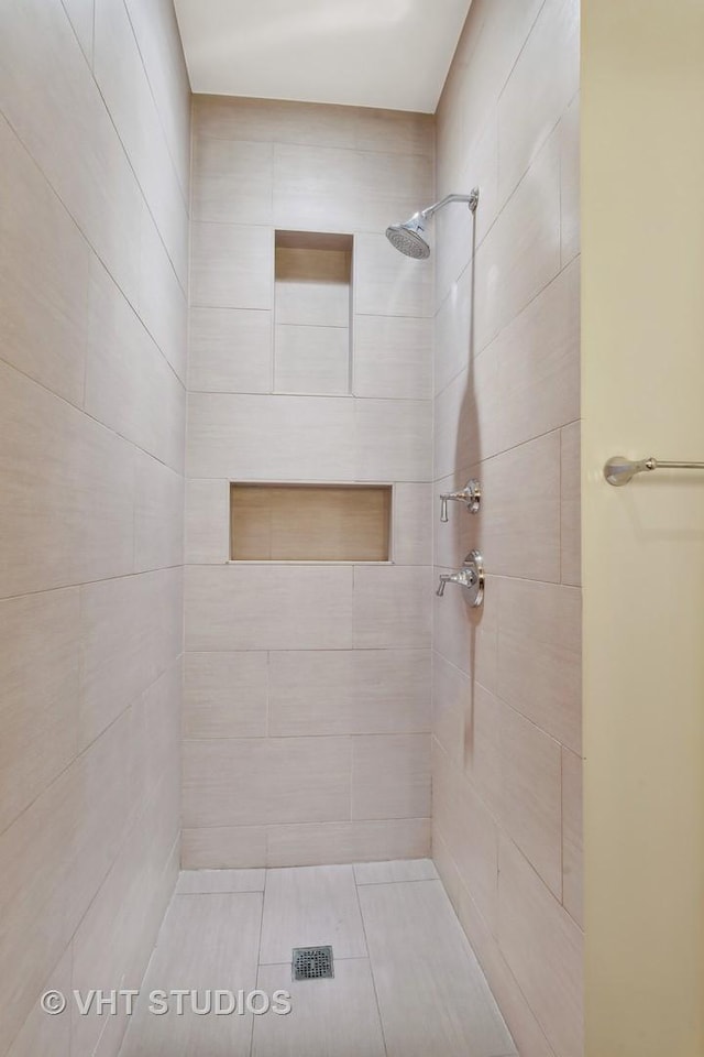 bathroom with tiled shower