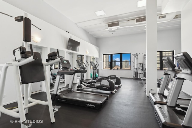 gym with a towering ceiling