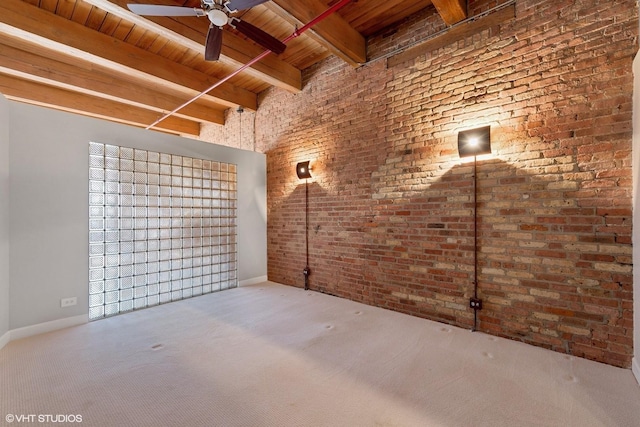 basement featuring wood ceiling, carpet floors, ceiling fan, and brick wall