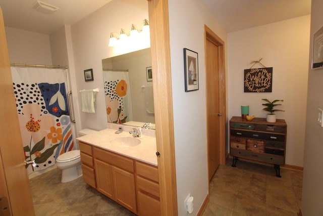 bathroom with toilet and vanity