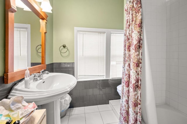 bathroom with shower / bath combination with curtain, toilet, and tile patterned flooring