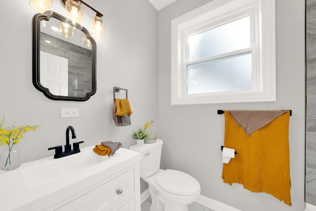 bathroom featuring toilet and vanity