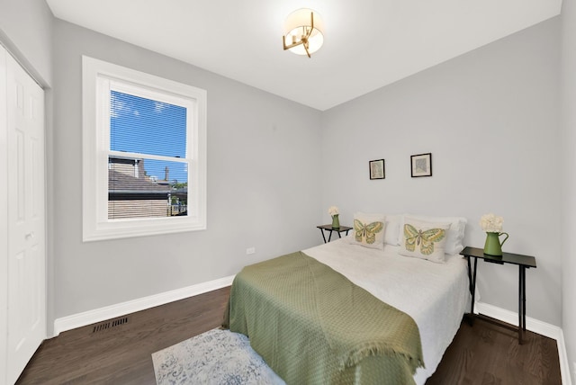 bedroom with a closet and dark hardwood / wood-style flooring