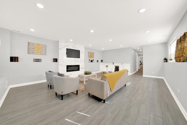 living room featuring a high end fireplace