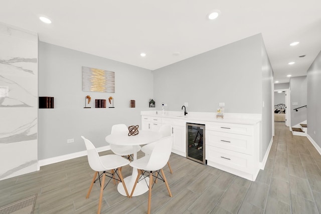 dining space with wet bar and beverage cooler