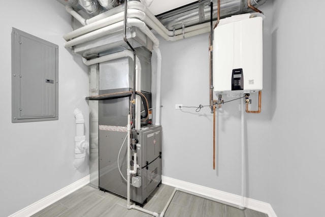 utility room featuring electric panel and tankless water heater