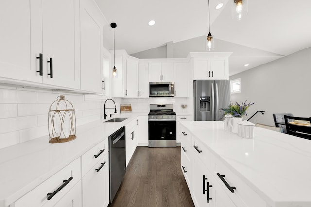 kitchen featuring hanging light fixtures, appliances with stainless steel finishes, and a kitchen island