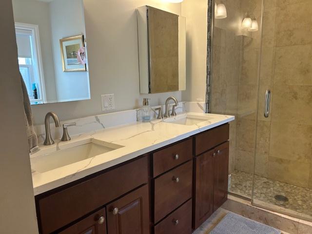 bathroom with vanity and a shower with shower door