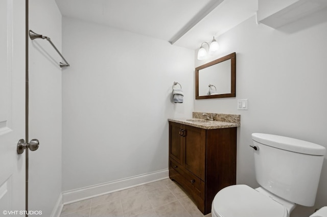 bathroom featuring vanity, tile patterned flooring, and toilet