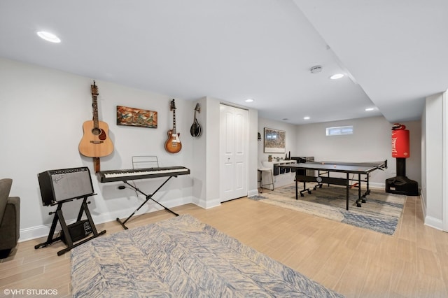 rec room with light hardwood / wood-style flooring