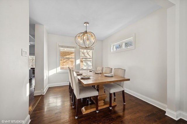 dining room with dark hardwood / wood-style flooring and a chandelier