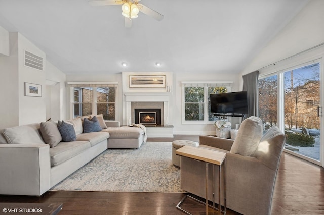 living room featuring vaulted ceiling, dark wood-type flooring, and ceiling fan