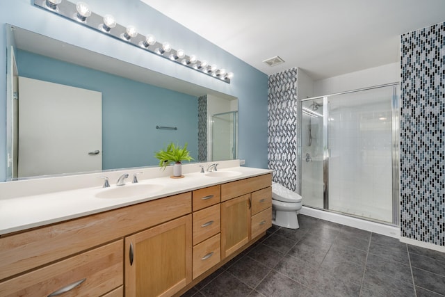 bathroom featuring vanity, an enclosed shower, and toilet