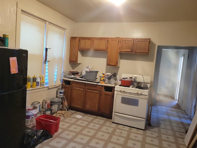 kitchen featuring black refrigerator and gas range gas stove