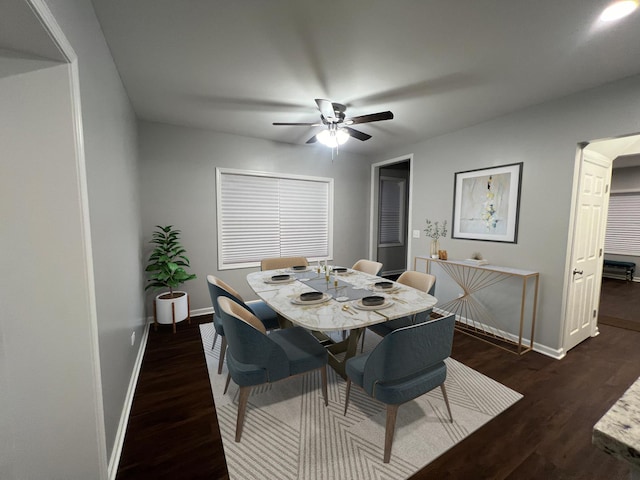 dining area featuring dark wood-type flooring and ceiling fan