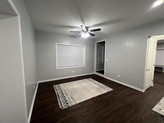 spare room featuring dark wood-type flooring and ceiling fan