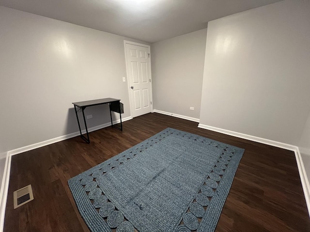 empty room featuring dark hardwood / wood-style flooring