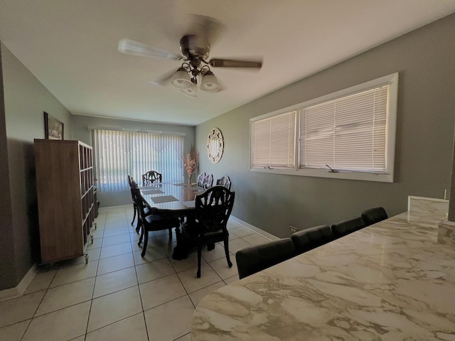 tiled dining area featuring ceiling fan