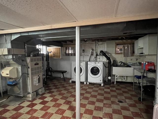 basement with separate washer and dryer and sink