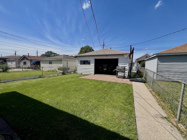 back of house featuring a garage, an outbuilding, and a yard