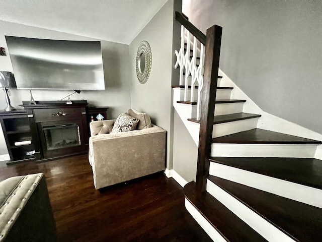 living room featuring lofted ceiling and dark wood-type flooring