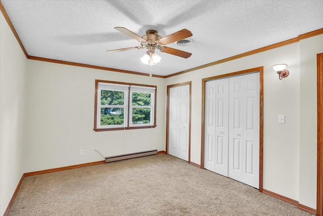 unfurnished bedroom with carpet floors, a textured ceiling, a baseboard heating unit, and ceiling fan