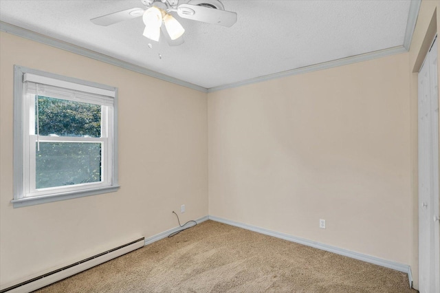 carpeted spare room featuring a baseboard heating unit, ceiling fan, a textured ceiling, and crown molding