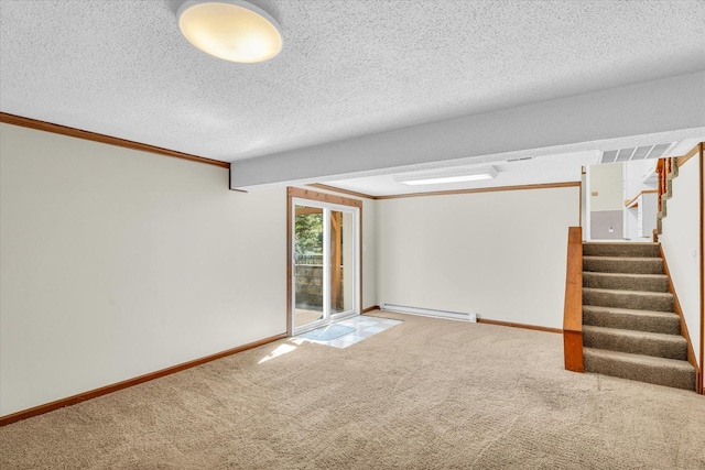 carpeted spare room with a baseboard heating unit, crown molding, and a textured ceiling