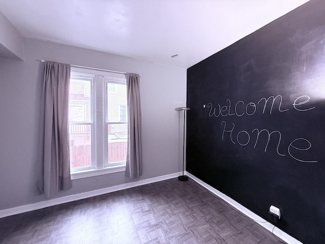 spare room featuring dark parquet floors