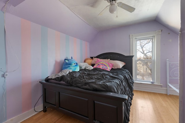 bedroom featuring ceiling fan, lofted ceiling, and light hardwood / wood-style floors