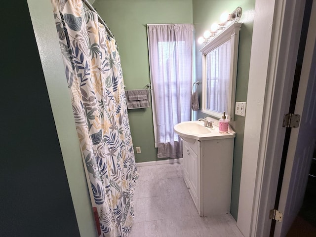 bathroom featuring vanity, tile patterned floors, and walk in shower