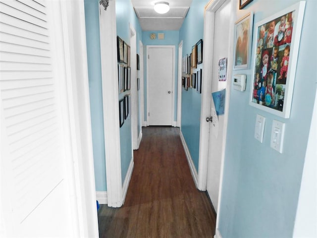 corridor with dark hardwood / wood-style flooring