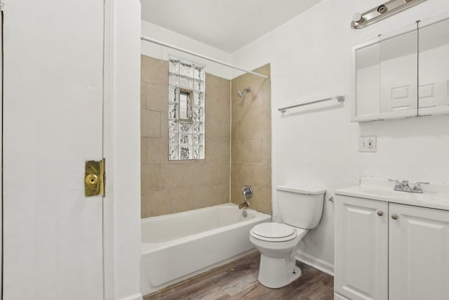 full bathroom with toilet, tiled shower / bath combo, vanity, and hardwood / wood-style floors