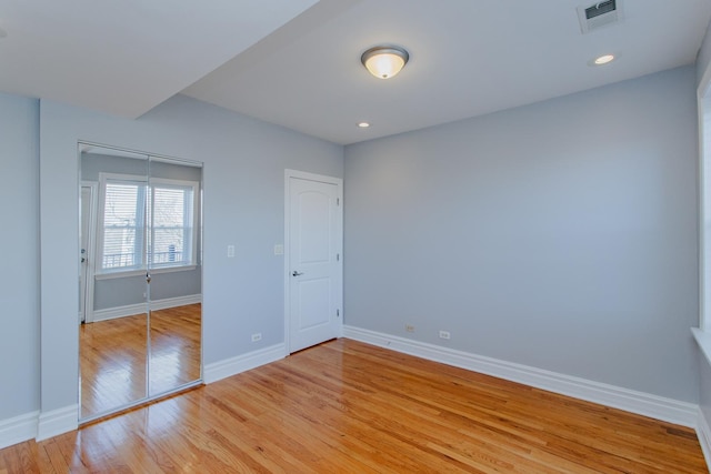 unfurnished bedroom featuring light wood-type flooring, visible vents, and baseboards