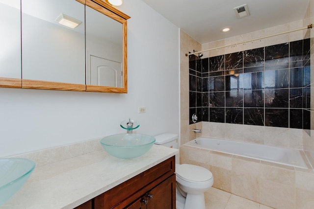 full bathroom with tile patterned floors, tiled shower / bath, visible vents, toilet, and vanity