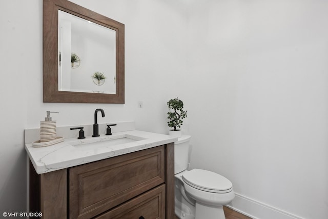 bathroom with toilet and vanity