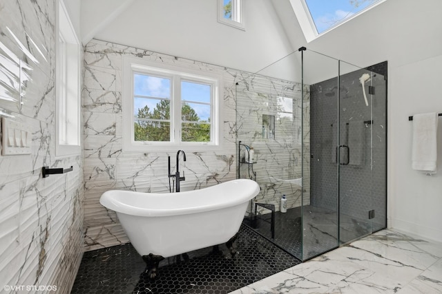 bathroom with tile walls, lofted ceiling with skylight, and shower with separate bathtub