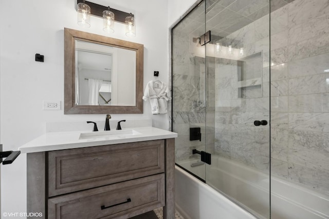 bathroom featuring vanity and shower / bath combination with glass door