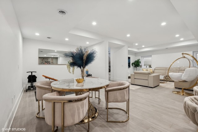 dining space with light hardwood / wood-style flooring