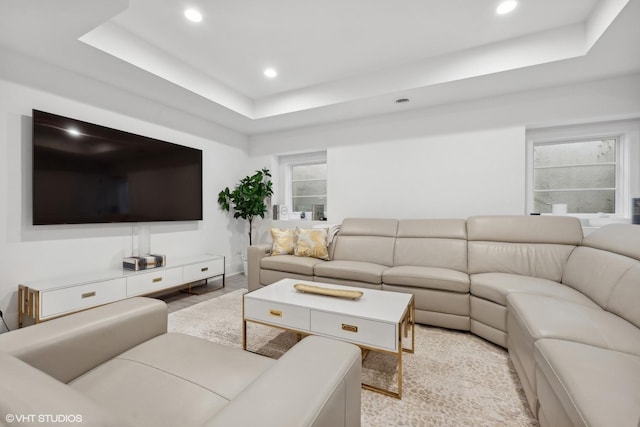 living room featuring a tray ceiling