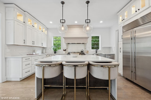 kitchen featuring appliances with stainless steel finishes, white cabinetry, and a kitchen island