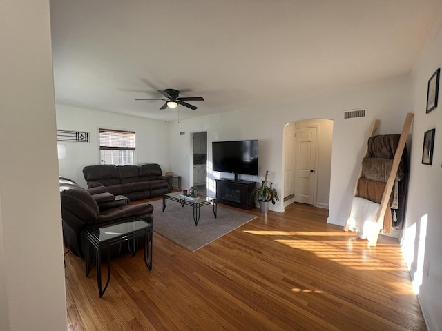 living room with ceiling fan and wood-type flooring