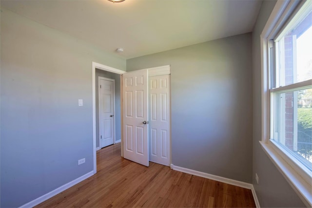 unfurnished bedroom featuring light hardwood / wood-style floors and a closet