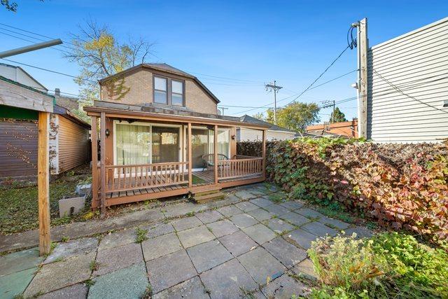 rear view of property featuring a deck and a patio area