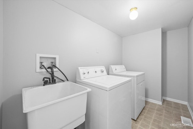 washroom with washer and dryer and sink