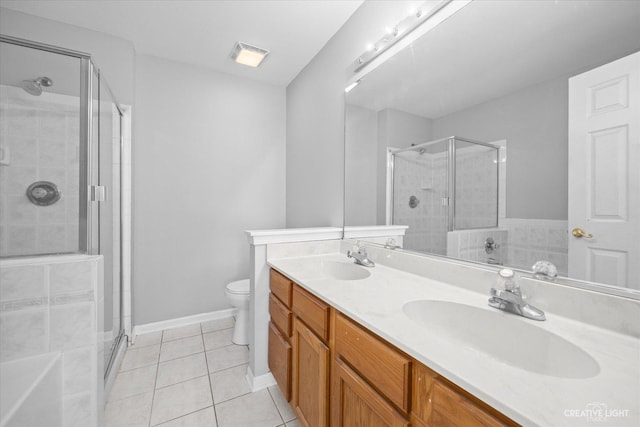 full bathroom featuring toilet, vanity, tile patterned flooring, and independent shower and bath