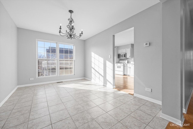 unfurnished dining area featuring light tile patterned floors and a chandelier