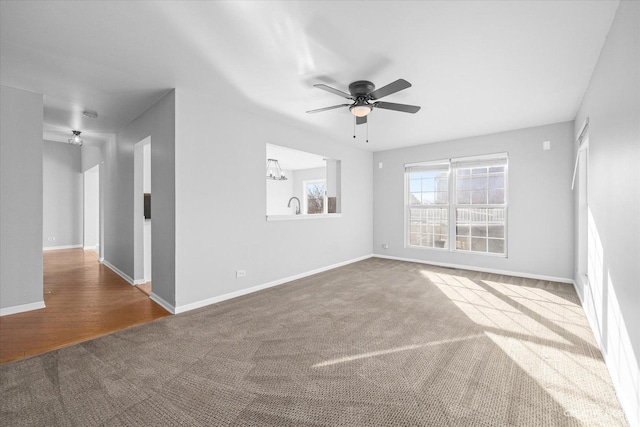 carpeted empty room featuring ceiling fan and sink